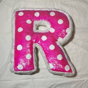 12x12 reversible pink and silver R shaped pillow from Justice